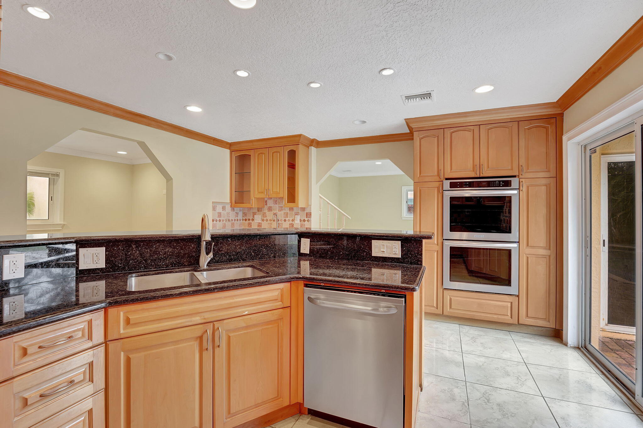 1300 Northeast 26th Avenue Pompano Beach, FL 33062 - Photo 59 of 68 a kitchen with granite countertop white cabinets and stainless steel appliances