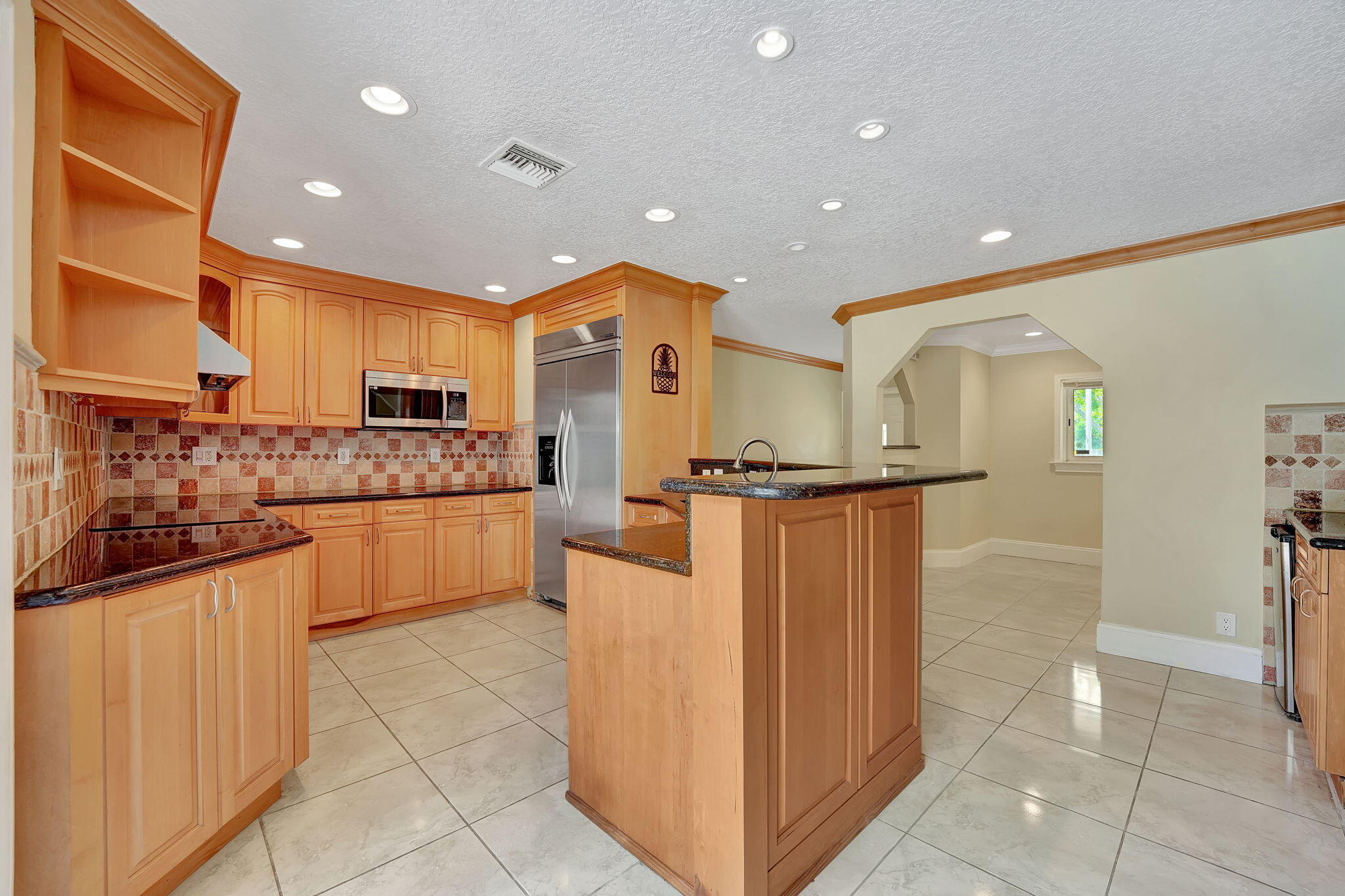 1300 Northeast 26th Avenue Pompano Beach, FL 33062 - Photo 62 of 68 a kitchen with stainless steel appliances granite countertop a refrigerator and a stove top oven