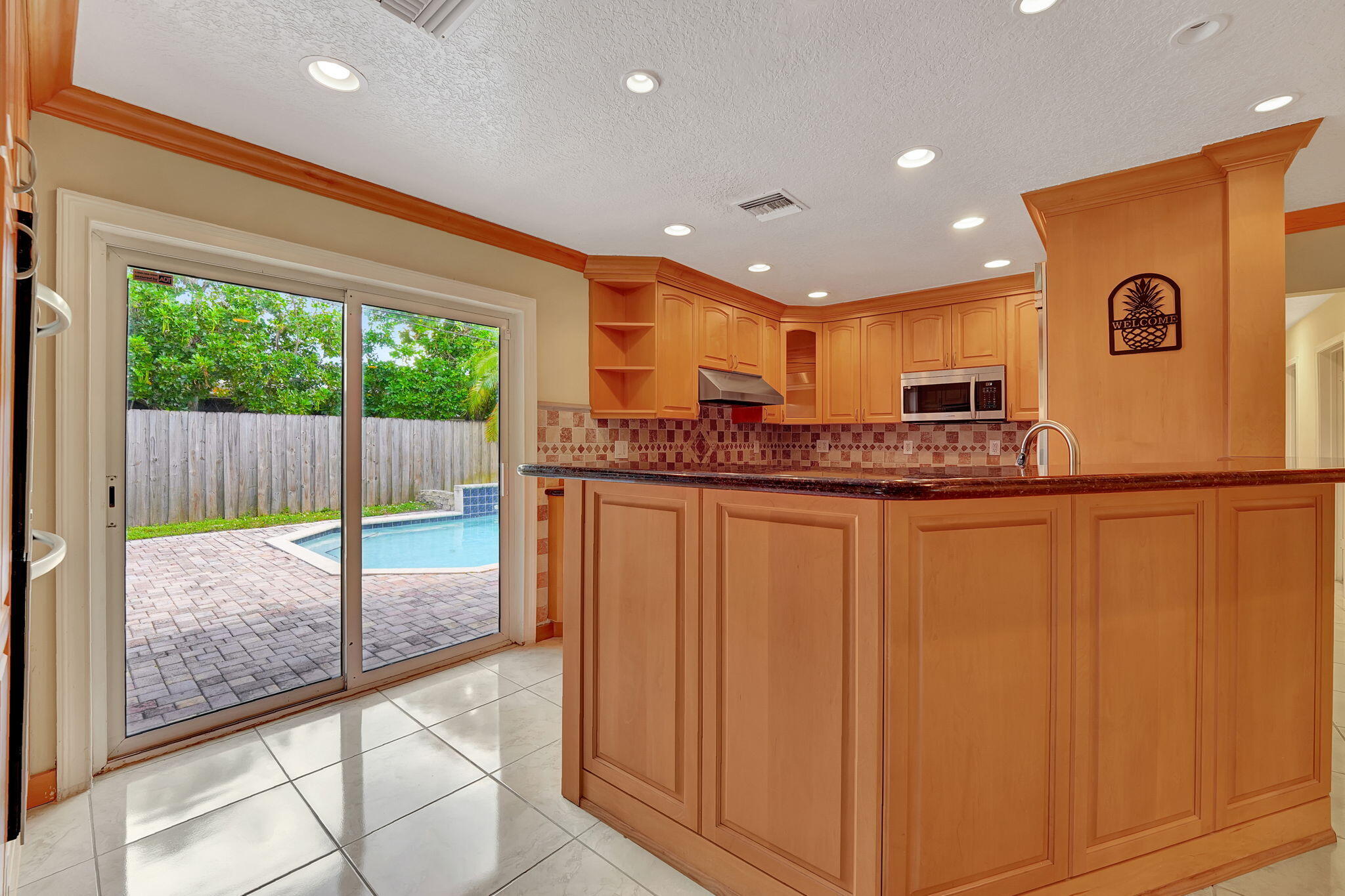 1300 Northeast 26th Avenue Pompano Beach, FL 33062 - Photo 63 of 68 a kitchen with stainless steel appliances granite countertop a refrigerator and a sink