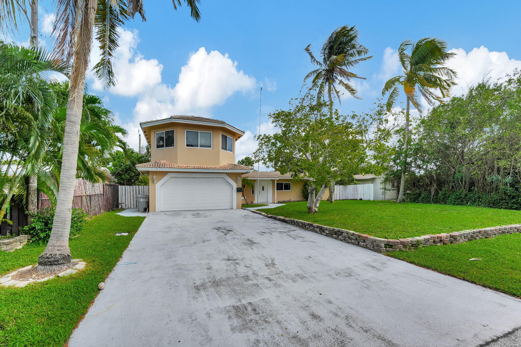 1300 Northeast 26th Avenue Pompano Beach, FL 33062 - Photo 68 of 68 a front view of a house with a garden and trees