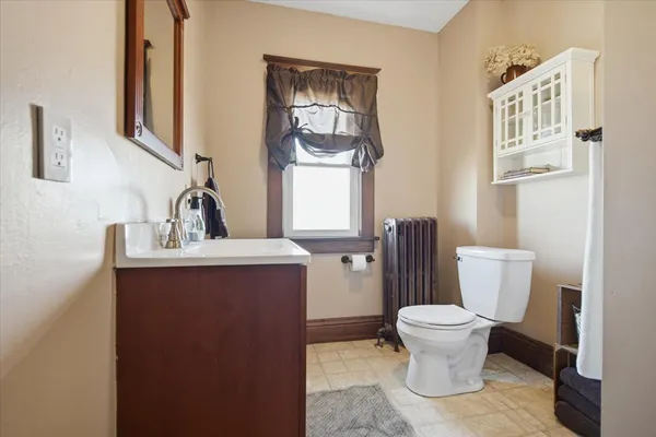 a bathroom with a toilet sink and mirror