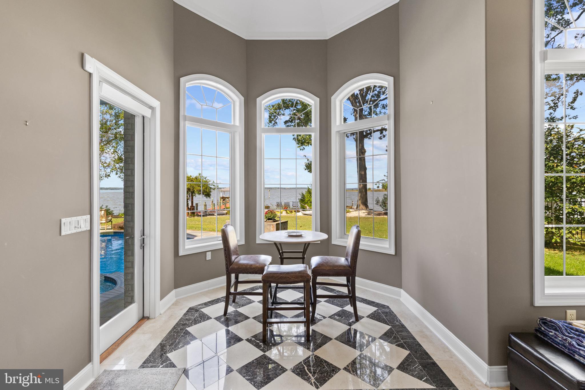 4819 Avery Road Shady Side, MD 20764 - Photo 11 of 44 a dining room with furniture and a floor to ceiling window