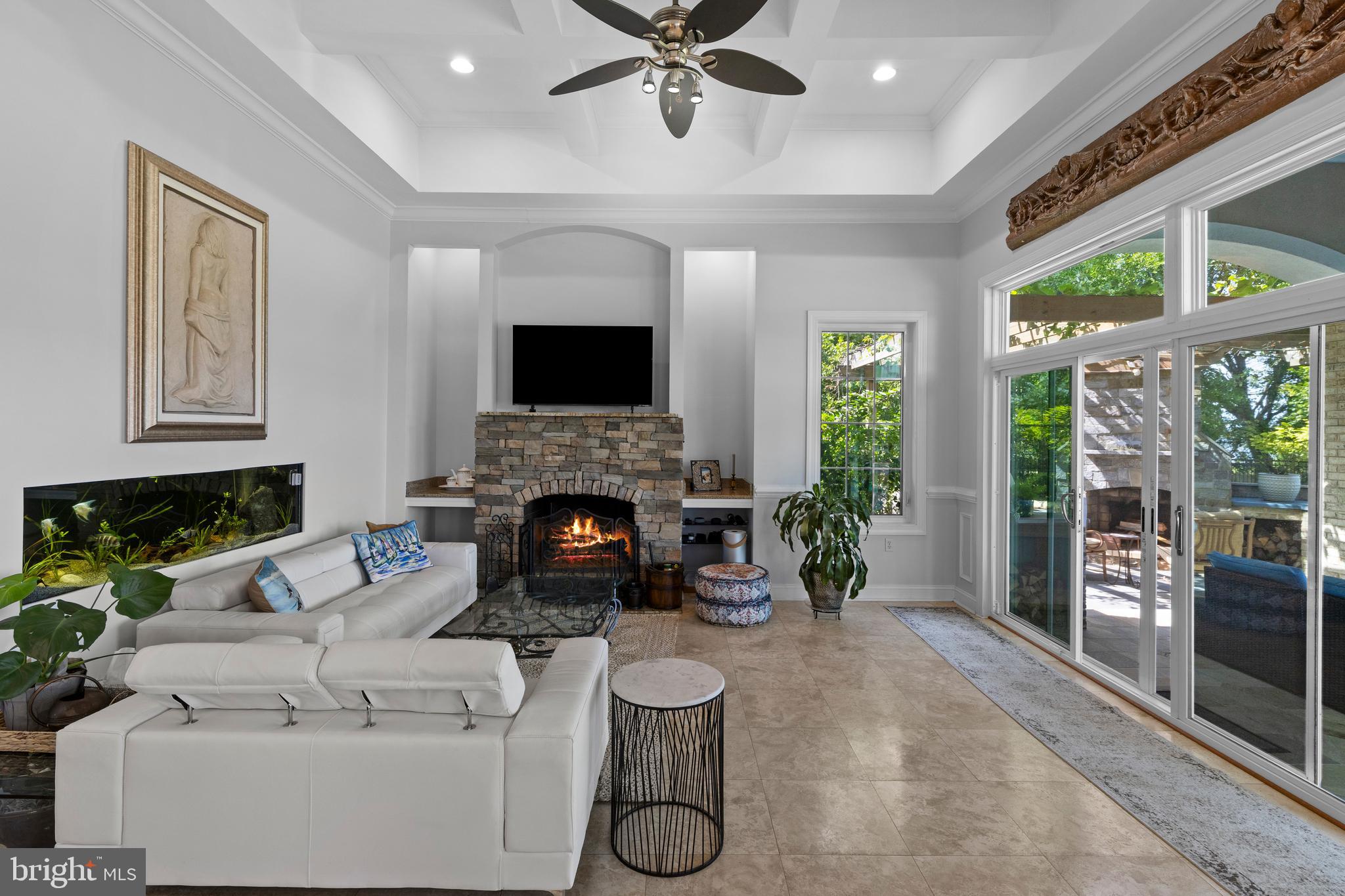 4819 Avery Road Shady Side, MD 20764 - Photo 21 of 44 a living room with furniture a fireplace and a flat screen tv