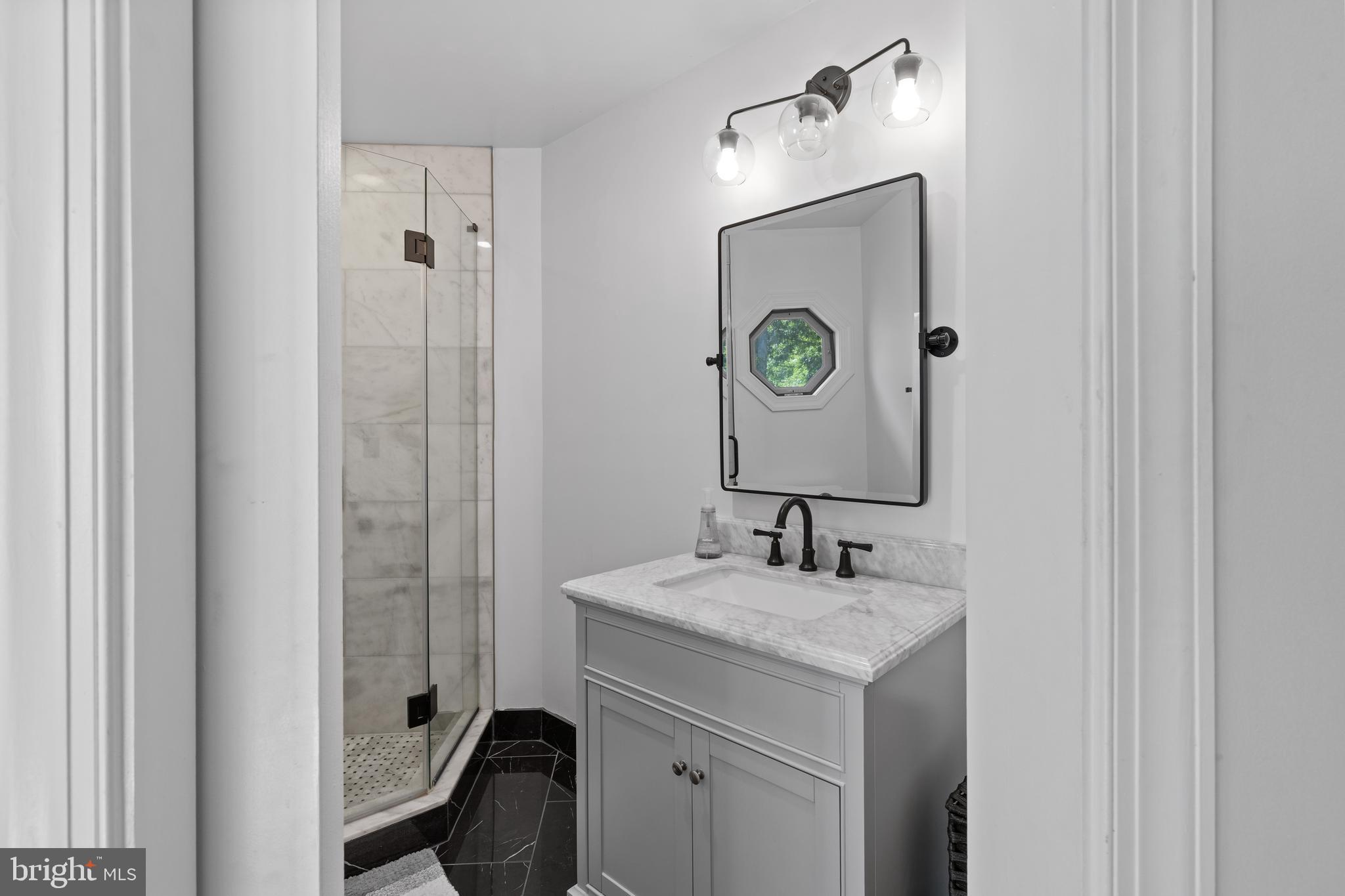 4819 Avery Road Shady Side, MD 20764 - Photo 28 of 44 a bathroom with a granite countertop sink and a mirror