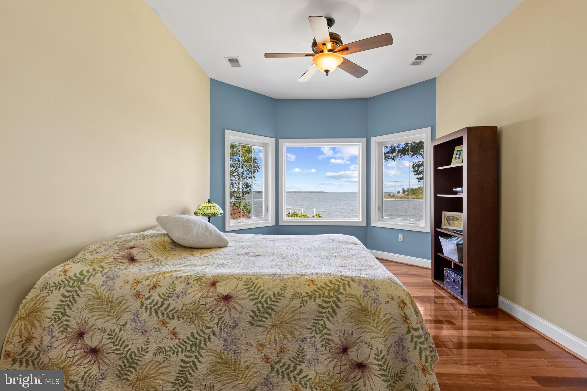4819 Avery Road Shady Side, MD 20764 - Photo 34 of 44 a bedroom with a bed and wooden floor