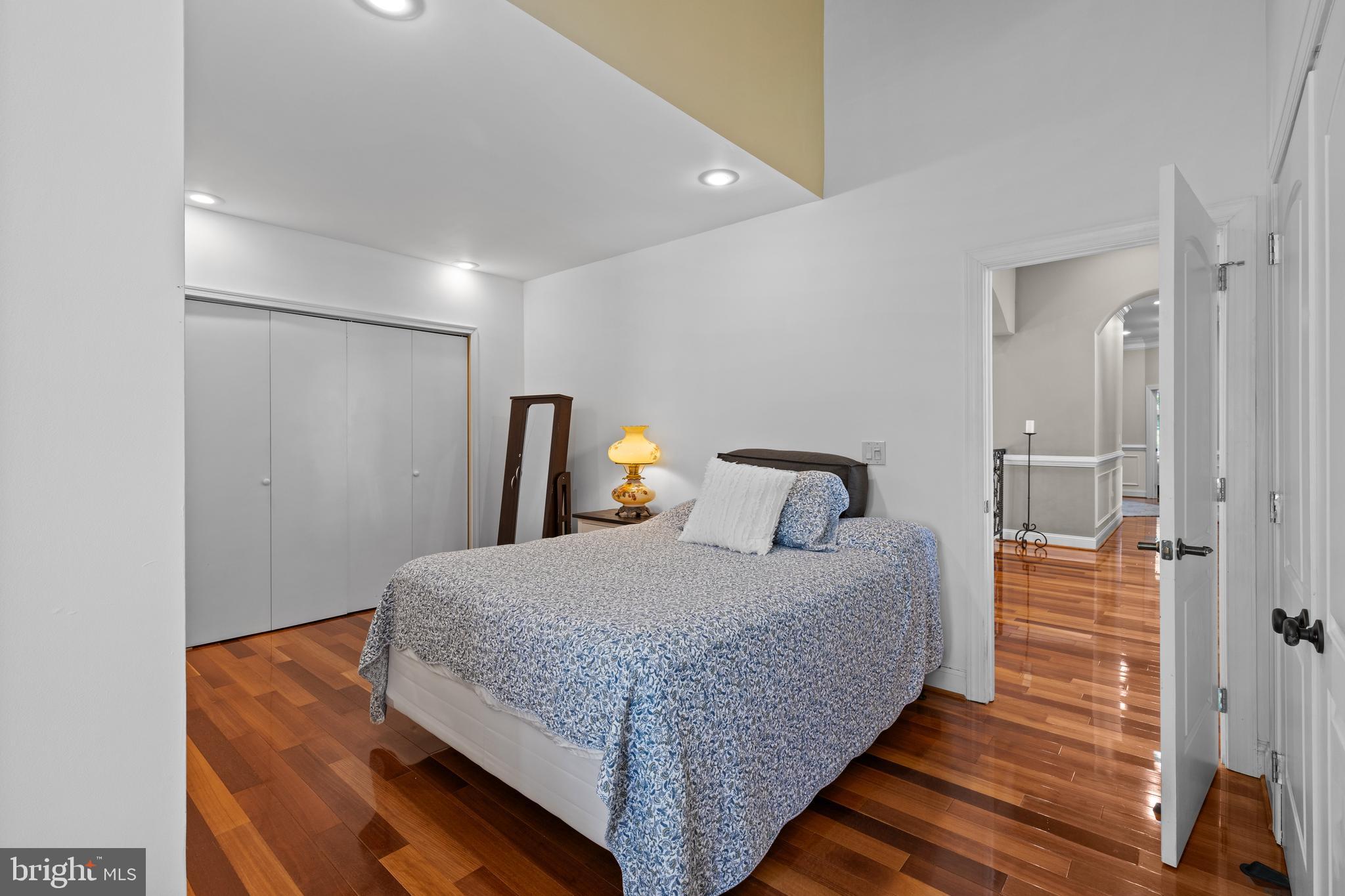 4819 Avery Road Shady Side, MD 20764 - Photo 35 of 44 a bedroom with a bed and wooden floor