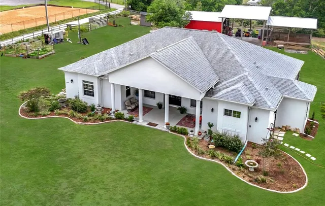 a aerial view of a house with table and chairs potted plants