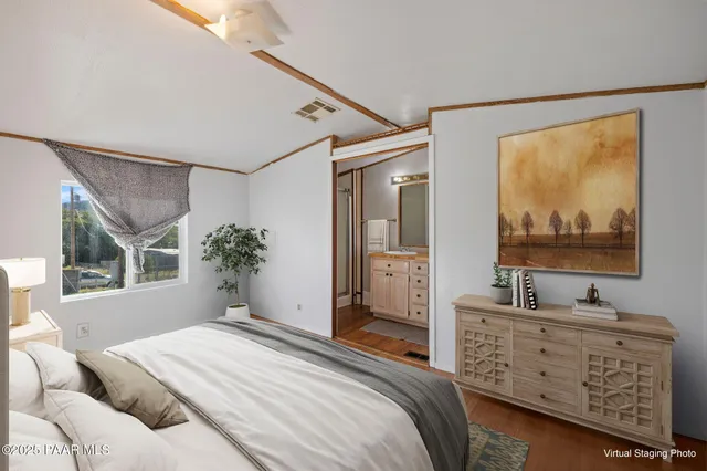 a bedroom with furniture and a window