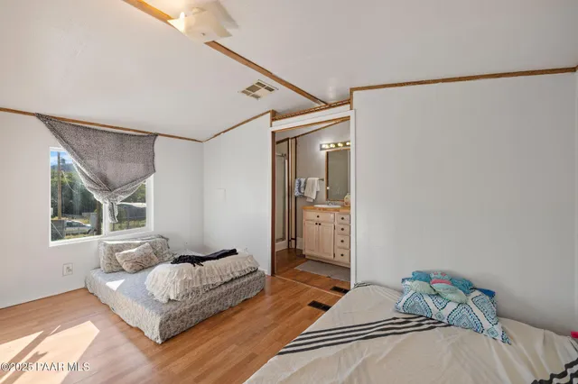 a bedroom with a bed and a window with the outer view