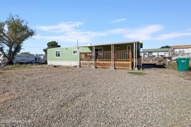 a view of a house with backyard and parking space