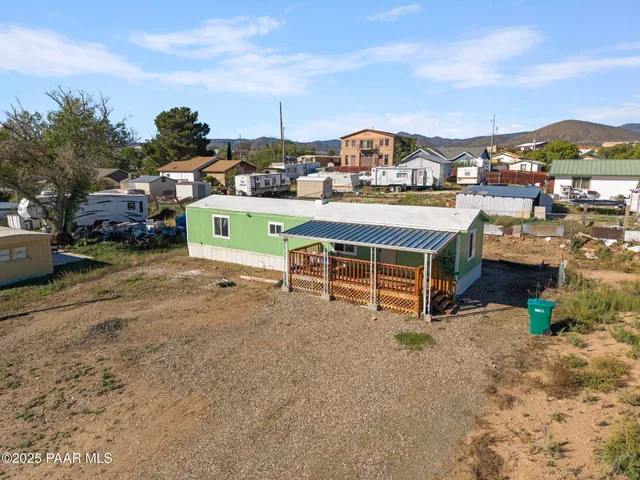 a view of a patio with a table chairs and a fire pit