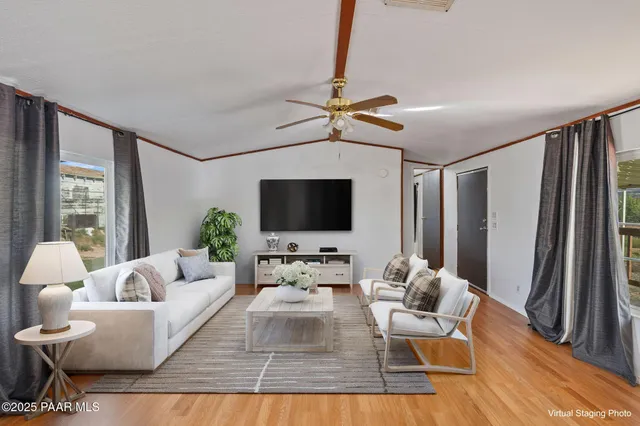 a living room with furniture wooden floor and a flat screen tv