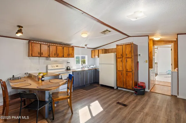 a kitchen that has a table and chairs in it