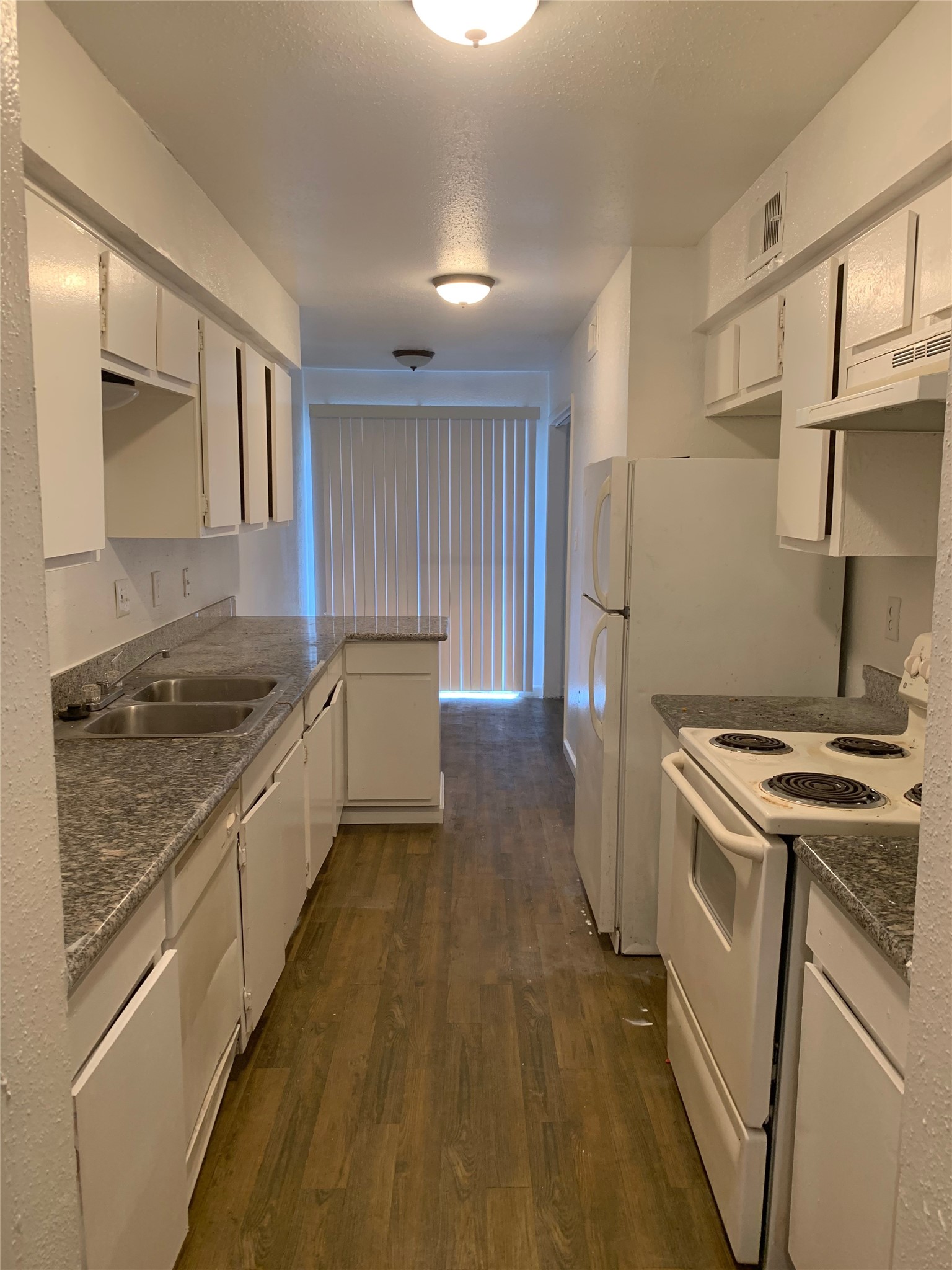 6200 West Tidwell Road, Unit 2701 Houston, TX 77092 - Photo 4 of 10 a kitchen that has a sink wooden floor and stainless steel appliances