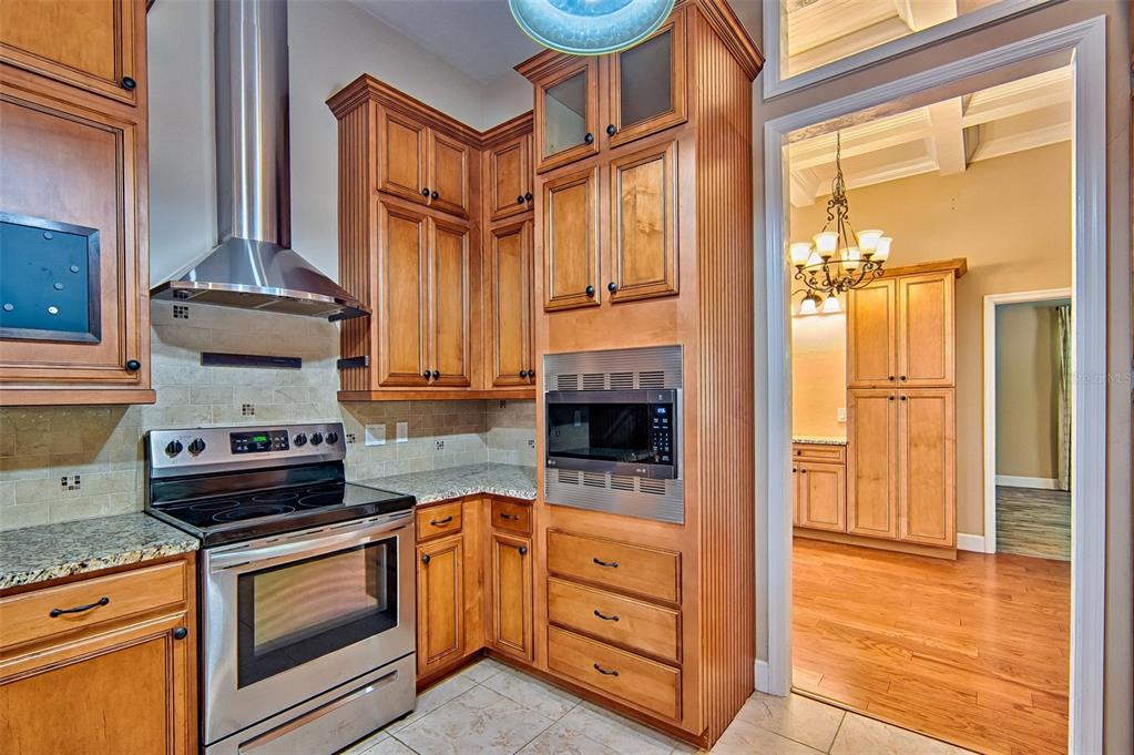 7546 Southwest 90th Drive Gainesville, FL 32608 - Photo 11 of 46 a kitchen with stainless steel appliances granite countertop a stove a sink and a refrigerator