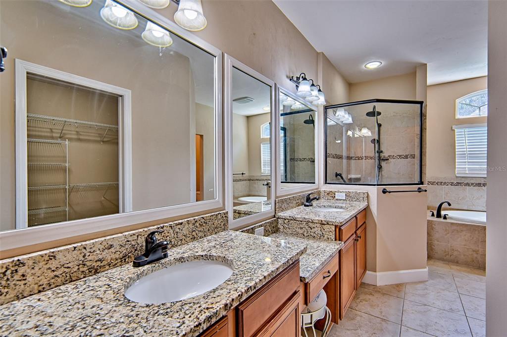7546 Southwest 90th Drive Gainesville, FL 32608 - Photo 18 of 46 a bathroom with a granite countertop sink and a mirror