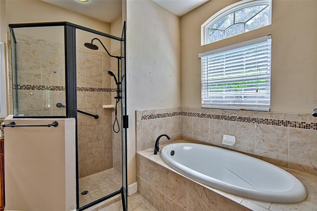 7546 Southwest 90th Drive Gainesville, FL 32608 - Photo 19 of 46 a bathroom with a bathtub and a shower