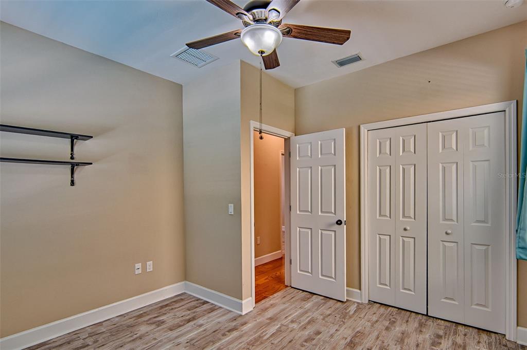 7546 Southwest 90th Drive Gainesville, FL 32608 - Photo 22 of 46 a view of an empty room with window and wooden floor