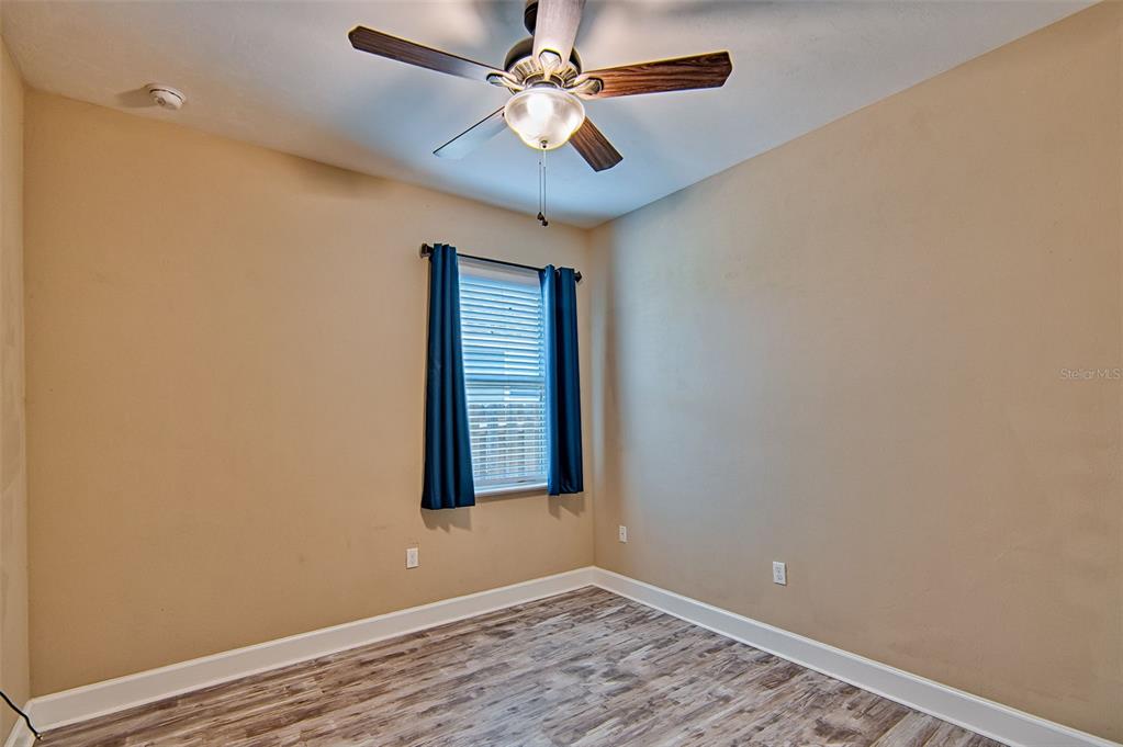 7546 Southwest 90th Drive Gainesville, FL 32608 - Photo 26 of 46 an empty room with a window and a fan