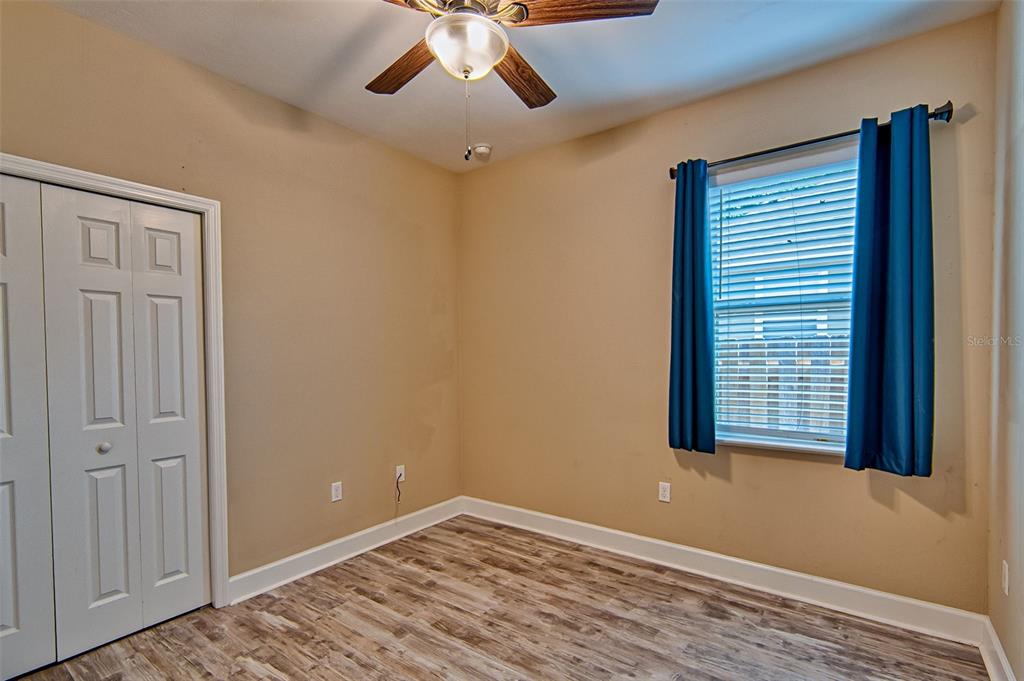 7546 Southwest 90th Drive Gainesville, FL 32608 - Photo 27 of 46 a view of an empty room with a window and wooden floor