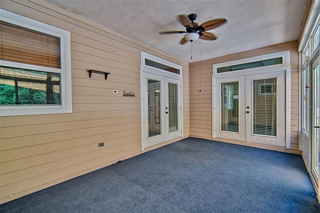 7546 Southwest 90th Drive Gainesville, FL 32608 - Photo 29 of 46 a view of a livingroom with a chandelier fan and windows