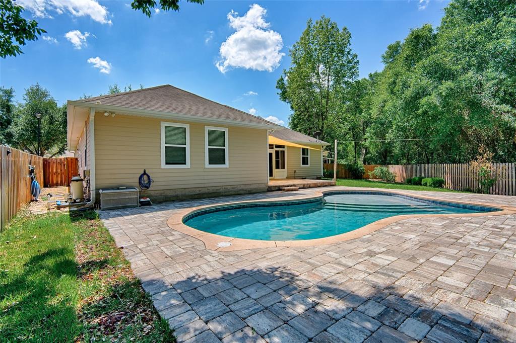 7546 Southwest 90th Drive Gainesville, FL 32608 - Photo 37 of 46 a front view of a house with a yard