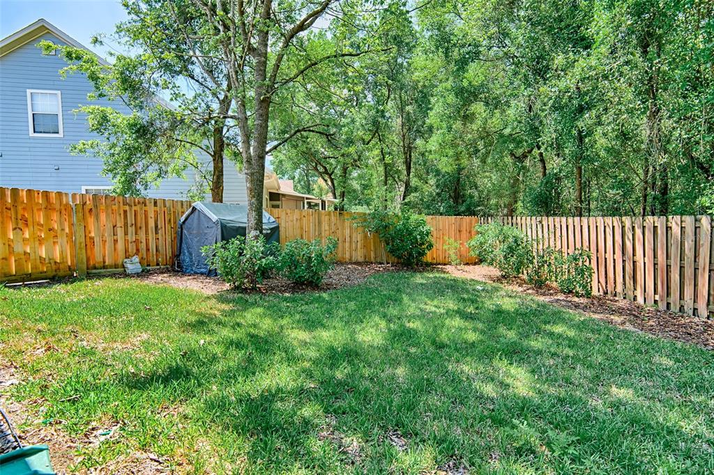 7546 Southwest 90th Drive Gainesville, FL 32608 - Photo 40 of 46 a view of a backyard with garden