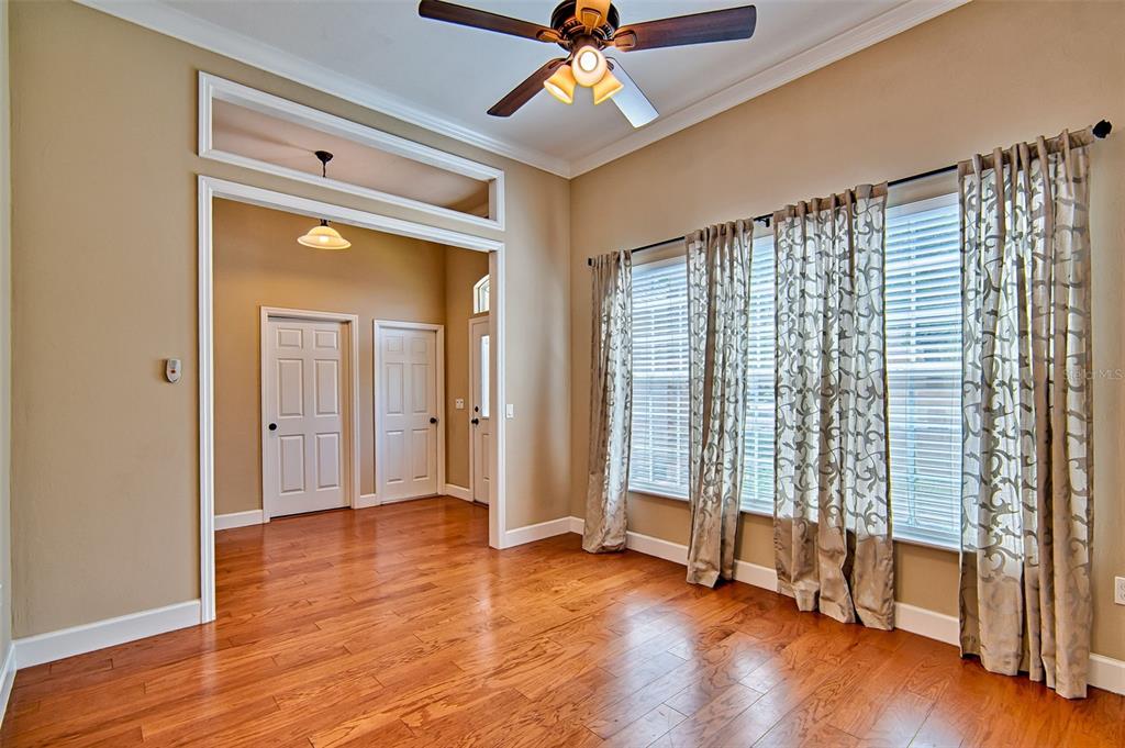 7546 Southwest 90th Drive Gainesville, FL 32608 - Photo 4 of 46 a view of an empty room with wooden floor and a window