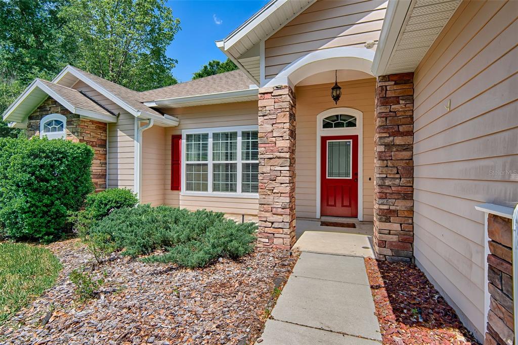 7546 Southwest 90th Drive Gainesville, FL 32608 - Photo 44 of 46 a front view of a house with a yard