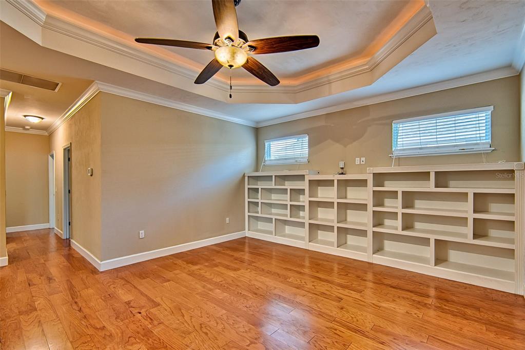 7546 Southwest 90th Drive Gainesville, FL 32608 - Photo 7 of 46 a view of a livingroom with wooden floor and a ceiling fan