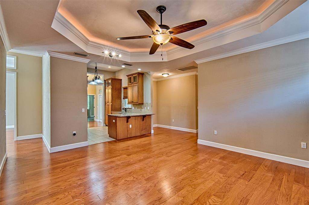 7546 Southwest 90th Drive Gainesville, FL 32608 - Photo 8 of 46 a view of empty room with wooden floor and fan