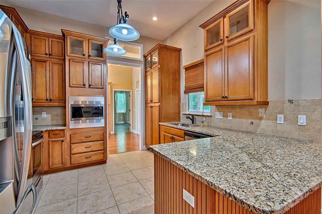 7546 Southwest 90th Drive Gainesville, FL 32608 - Photo 9 of 46 a kitchen with stainless steel appliances granite countertop a refrigerator a oven and a sink