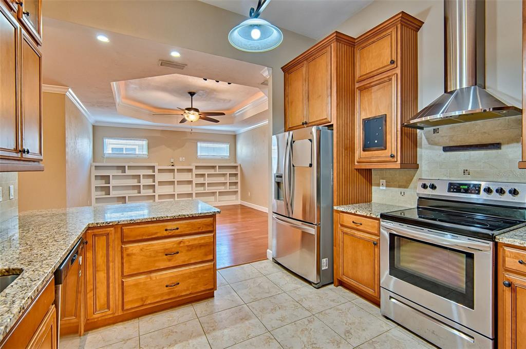 7546 Southwest 90th Drive Gainesville, FL 32608 - Photo 10 of 46 a kitchen with stainless steel appliances granite countertop a refrigerator and a stove top oven