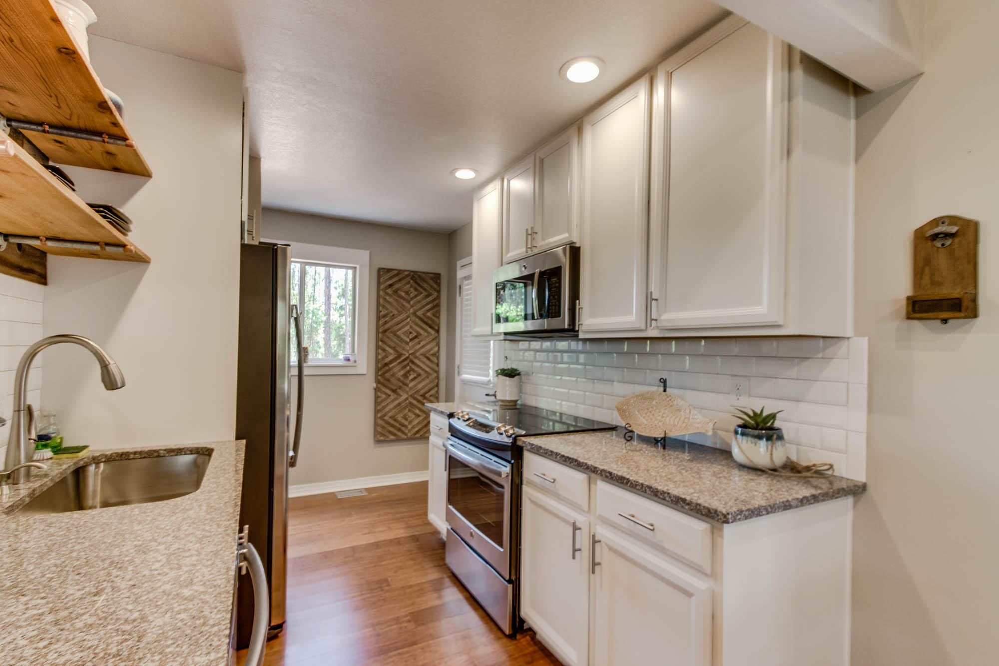 46 Cypress Pond Road Santa Rosa Beach, FL 32459 - Photo 18 of 36 a kitchen with stainless steel appliances granite countertop a sink a stove and a refrigerator