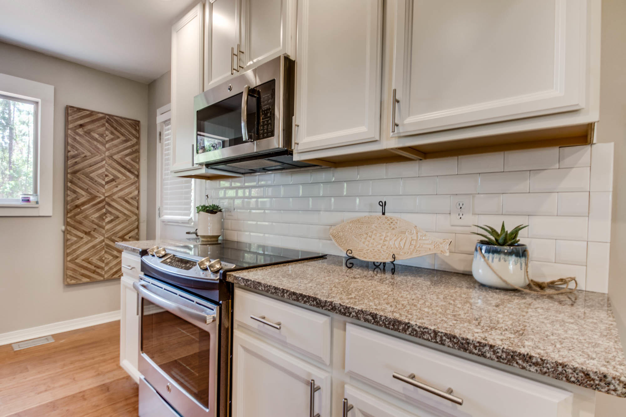 46 Cypress Pond Road Santa Rosa Beach, FL 32459 - Photo 19 of 36 a kitchen with granite countertop a sink a stove and microwave