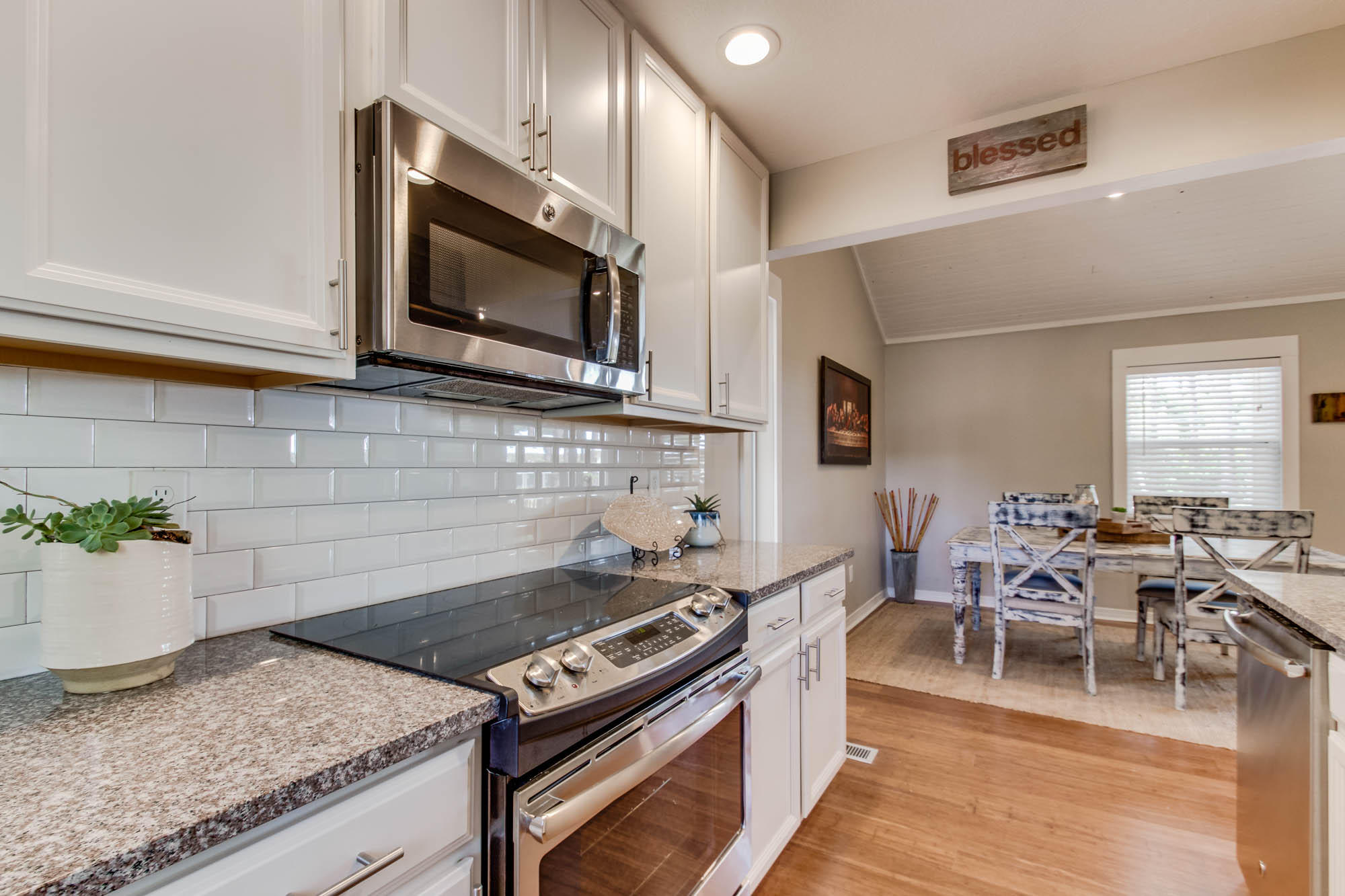 46 Cypress Pond Road Santa Rosa Beach, FL 32459 - Photo 25 of 36 a kitchen with stainless steel appliances granite countertop a stove top oven a sink dishwasher a dining table and chairs with wooden floor