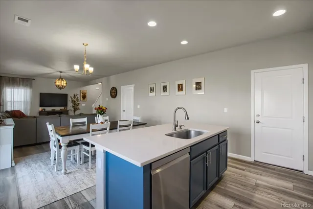 a kitchen with sink cabinets and dining table