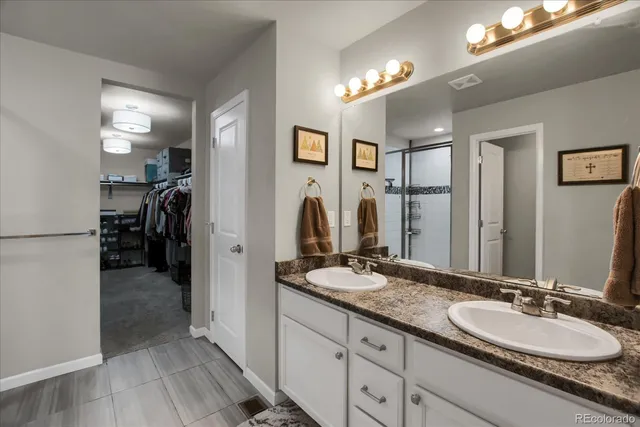 a view of walk in closet with clothes