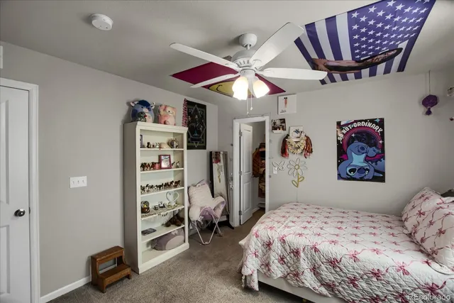 a bedroom with a bed window and a desk