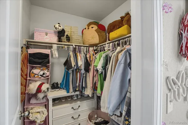 a bathroom with a granite countertop sink a mirror and shower