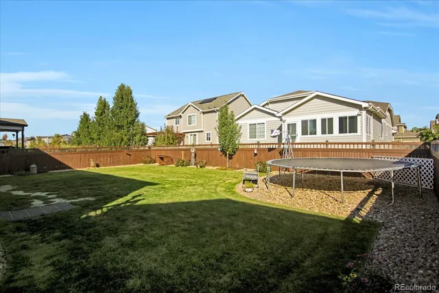 a view of a large building with a big yard and large trees