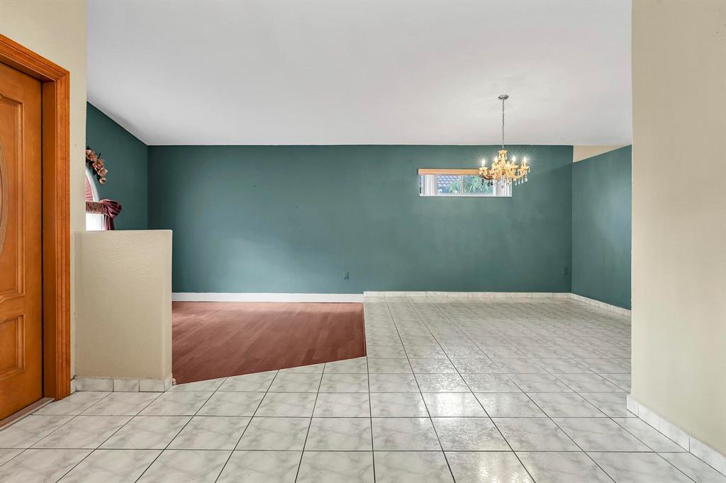 3201 West 76th Street Hialeah, FL 33018 - Photo 11 of 46 a view of an empty room with window and chandelier