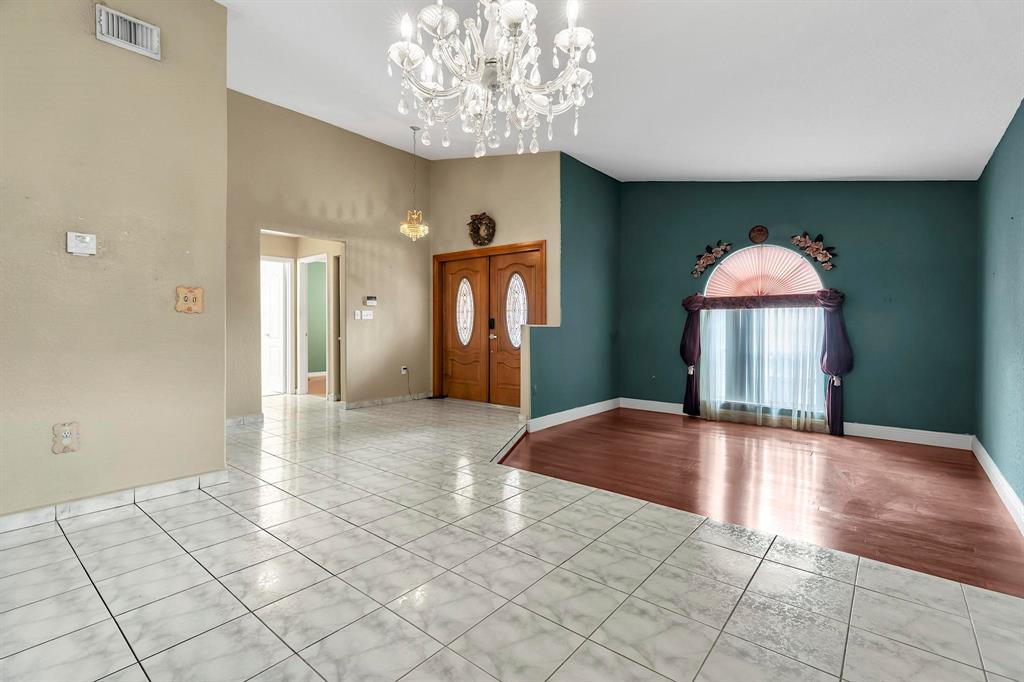 3201 West 76th Street Hialeah, FL 33018 - Photo 14 of 46 an empty room with a chandelier and windows