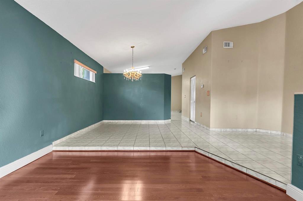 3201 West 76th Street Hialeah, FL 33018 - Photo 17 of 46 an empty room with wooden floor and mirror