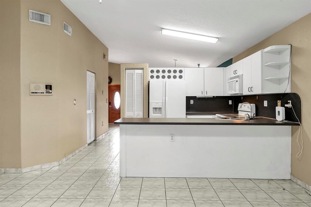 3201 West 76th Street Hialeah, FL 33018 - Photo 22 of 46 a view of a refrigerator a sink and dishwasher with wooden floor