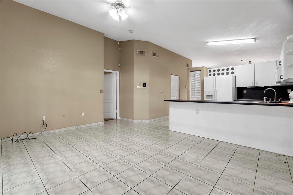 3201 West 76th Street Hialeah, FL 33018 - Photo 23 of 46 a view of a refrigerator in kitchen and white cabinets