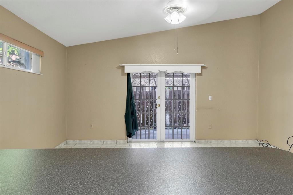 3201 West 76th Street Hialeah, FL 33018 - Photo 25 of 46 a view of an empty room with wooden floor and a window