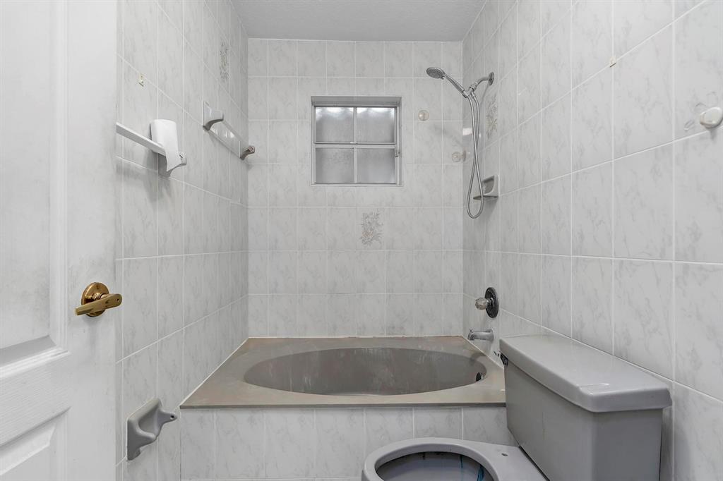 3201 West 76th Street Hialeah, FL 33018 - Photo 30 of 46 a bathroom with a tub a toilet and a shower