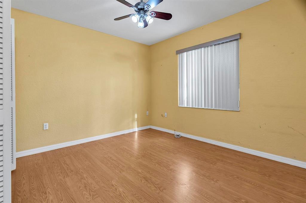 3201 West 76th Street Hialeah, FL 33018 - Photo 38 of 46 an empty room with a window and wooden floor