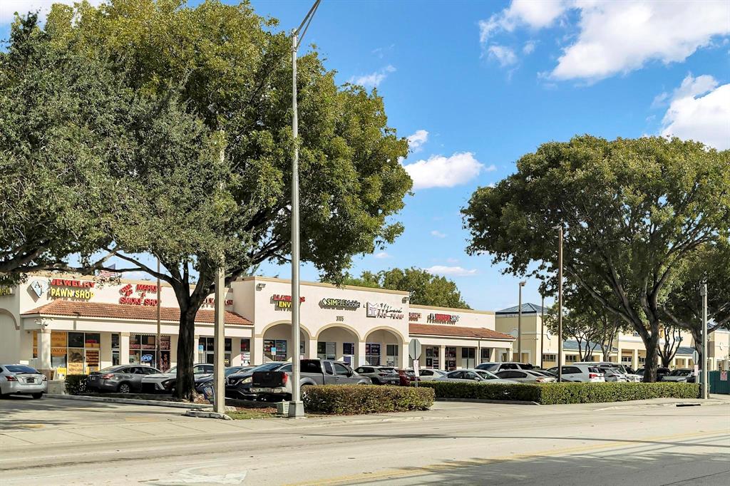 3201 West 76th Street Hialeah, FL 33018 - Photo 46 of 46 a front view of a building with lot of cars and trees